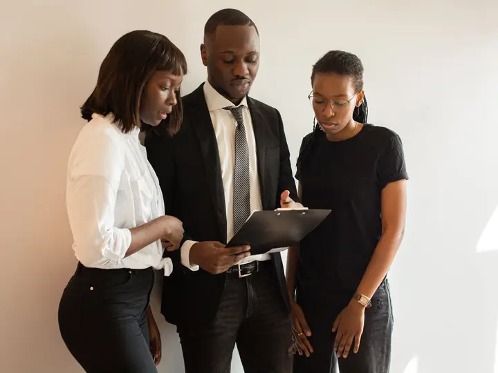 A supervisor reviewing documents with two colleagues